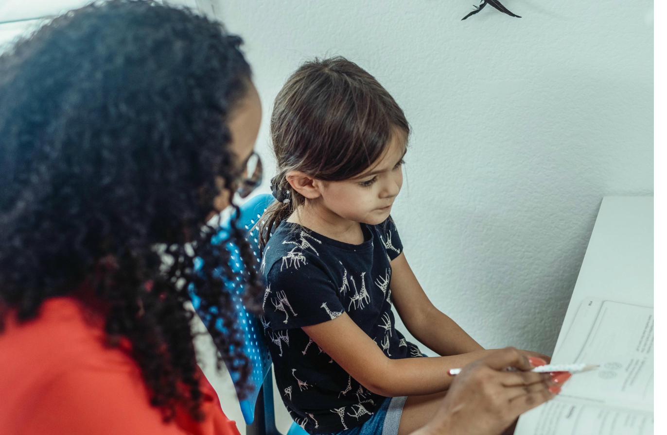 Child in a learning session with a tutor at home